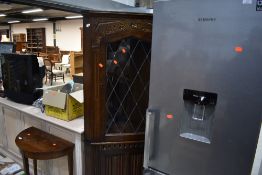 A vintage oak corner display having cupboard under, with linen fold doors, height approx. 176cm