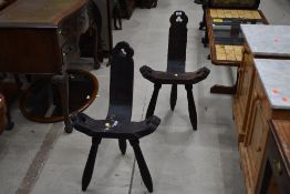 A pair of interesting rustic chairs , on tripod legs with clover motifs