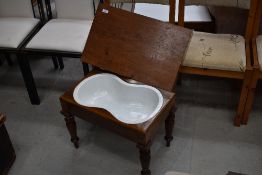 A Victorian mahogany bidet (or baby bath) on turned legs