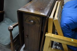 A mid 20th Century oak gateleg table having cupboard and drawer ends
