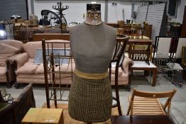 A vintage dressmakers dummy female formon wooden tripod base