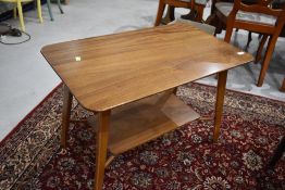 A vintage sapele coffee table approx 76 x 46cm with splay legs and undertier