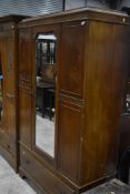 An early 20th Century mahogany mirror door wardrobe having drawer base, width approx. 120cm