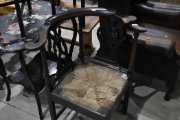 A 19th Century oak rush seated elbow chair, damage to one end but piece is present