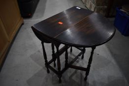 An early 20th Century dwarf oak gateleg occasional table