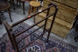 A late Victorian or Edwardian mahogany and inlaid towel rail, string repair to one rail, width
