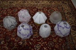 A box of vintage opaque glass light shades