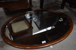 An Edwardian mahogany and inlaid oval wall mirror, approx 87 x 62cm