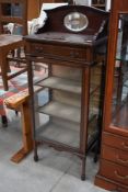 An Edwardian mahogany and inlaid narrow display cabinet having mirror back and frieze drawer,