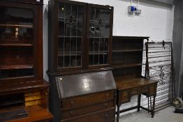 A late Victorian oak bureau bookcase having leaded and coloured glass upper section, no plinth,