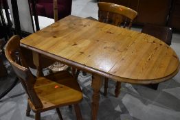 A modern pine drop leaf breakfast table and two chairs