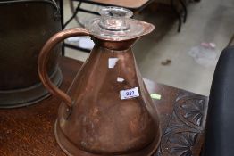 A vintage copper jug and glass measure