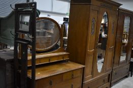 An Art Nouveau period golden oak mirror door wardrobe and dressing table