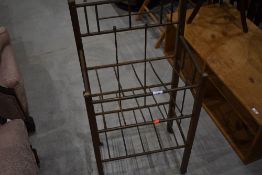 A transitional (art deco/art nouveau) mahogany and brass rack, possibly paper vending