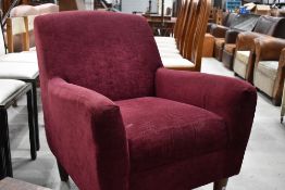 A modern tub chair, in burgundy, labelled for John Lewis
