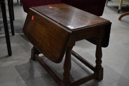 A nice quality reproduction oak occasional table having drope leaves and twist top, width approx
