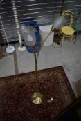 A modern brass effect three branch tulip style standard lamp