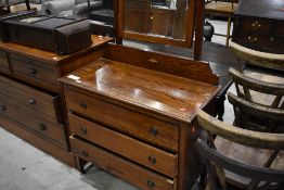 An early 20th Century oak dressing table, having shaped mirror back over three drawers, width