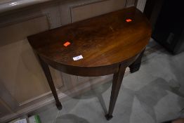 An early 20th Century mahogany half moon table, of small proportions, on spade feet, width approx.