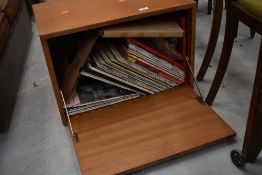 A vintage teak record cabinet and contents