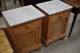 A pair of stripped pine and marble top pot cupboards