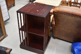 A reproduction mahogany effect revolving bookcase