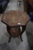 A carved octagonal table, leg broken