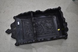 A dark stained wall shelf, panel dated 1765, some worm and damage to top