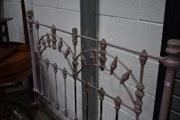 A Victorian cast iron bed frame, 138cm (4ft6) , very heavy iron, over painted in lilac