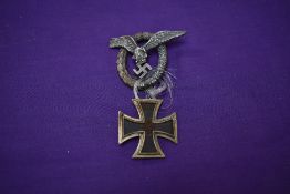 A German WW2 1st Class Iron Cross dated 1939 and a German WW2 Pilot's Badge, makers marks CEJ on