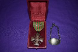 A French WW1 Croix de Guerre 1914/18 Medal with ribbon and having two stars along with a white metal