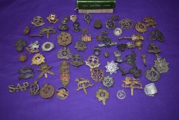 A collection of Military Cap Badges including The Buffs, Devonshire, Middlesex, Suffolk, Borders,