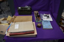 A WW2 British Kharki Map Case, a Military Field Telephone Set L MK1, a piece of brass Royal