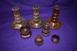 Seven pieces of treen, candlesticks from the teak of HMS Birmingham and HMS Ganges, HMS Ajax,