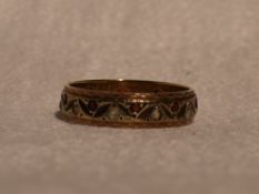 A lady's eternity ring having red and white paste decoration in a decorative 9ct gold band, size M &
