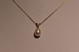 A cultured tear drop pearl and diamond chip pendant on a 9ct gold chain, approx 18' & 1.3g