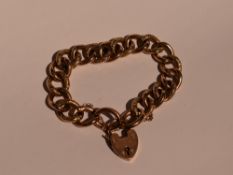 A rose gold curb chain bracelet having alternate decorative links and a padlock clasp stamped 9C,