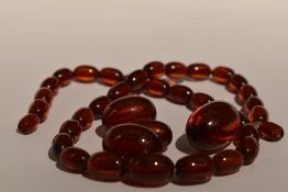 A string of cherry amber style graduated beads having broken barrel clasp, with 3 extra beads