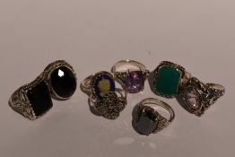 Eight white metal dress rings including hematite, marcasite, amethyst style etc