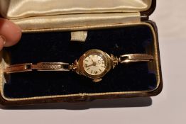 A lady's vintage 9ct gold wrist watch by Leda having a baton and Arabic numeral dial to small face