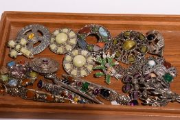 A selection of Scottish and Celtic style brooches including dirks, hardstone, enamelled heather