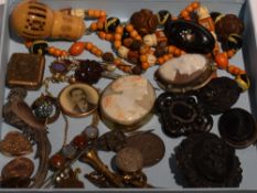 A selection of vintage jewellery including carved mourning brooches, conche shell cameos in