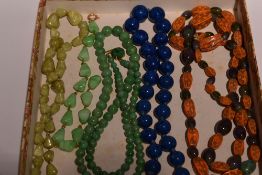 Four vintage strings of beads including a short string of Lapis Lazuli, green marble, jadeite