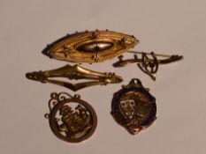 A small selection of 9ct gold and yellow metal including Cumberland football medal, bar brooches,