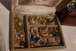 A small jewellery case containing a selection of modern costume jewellery enamelled and diamante
