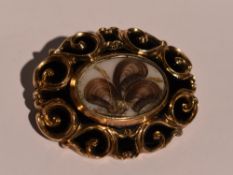 A Victorian mourning brooch having hair panel within a black enamel border, dated 1891 to reverse,