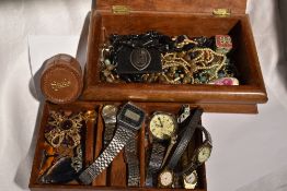 A wooden jewellery box having schooner marquetry decoration to lid and containing a selection of