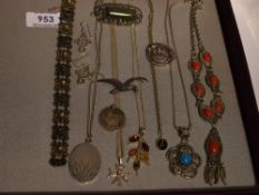 A selection of silver and white metal jewellery including pendants, locket, brooches, earrings,