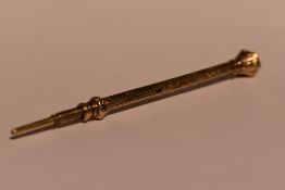 A Victorian yellow metal propelling pencil having citrine set terminal and engraved decoration, no