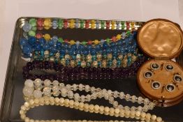 Six strings of vintage beads including mother of pearl, multi coloured glass etc and a cased set